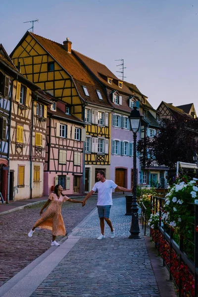 Colmar, Alsacia, Francia. Petite Venice, canal de agua y casas tradicionales de entramado de maderas.Pareja hombre y mujer caminando por la calle durante las vacaciones Colmar es una encantadora ciudad en Alsacia, Francia — Foto de Stock