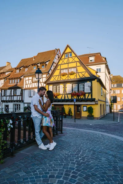 Colmar, Alsace, France. Petite Venice, water canal and traditional half timbered houses.couple man and woman walking at the street during vacation Colmar is a charming town in Alsace, France