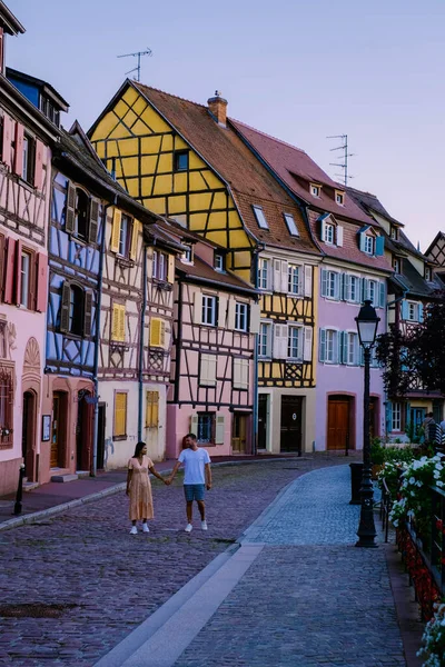 Colmar, Alsace, France. Petite Venice, water canal and traditional half timbered houses.couple man and woman walking at the street during vacation Colmar is a charming town in Alsace, France