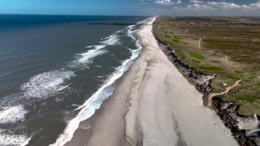 Yumuşak kumlu kıyıların engin okyanusla buluştuğu Danimarka 'nın güzel sahil şeridini keşfedin. Dalgalar yavaşça akarak sakin ve rahatlatıcı bir atmosfer yaratıyor. Doğal aşıklar ve maceracılar için ideal..