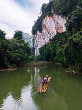 İki maceracı, yüksek uçurumlar ve yoğun tropikal ormanlarla çevrili Khao Sok Tayland 'ın yemyeşil sularında bir bambu salında huzur içinde süzülüyor. Doğaya mükemmel bir kaçış..