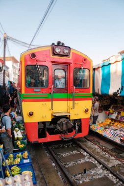 Tayland 'daki hareketli Maeklong Demiryolu Pazarı' nı keşfedin, canlı tezgahların taze ürünler ve yerel ürünler sattığı yer. Bangkok 'taki demiryolu hattında Taze Pazar, ünlü bir demiryolu pazarı.