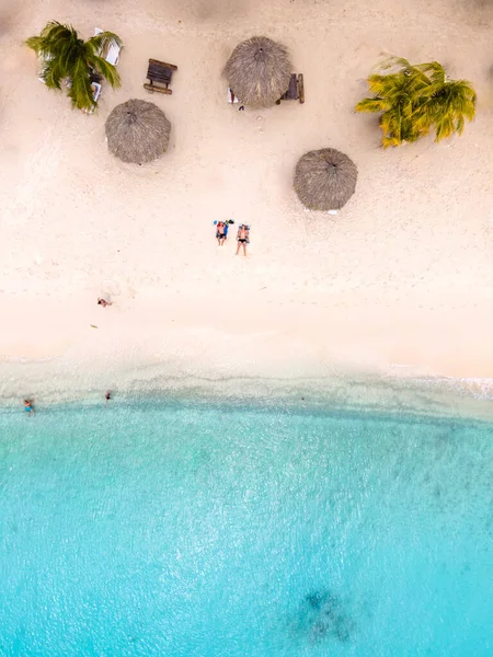Ziyaretçiler, Cas Abao Sahili 'nin yumuşak kumlu sahillerinde sazlı şemsiyelerin altında dinleniyorlar. Canlı turkuaz su, güneşin altında yüzmeye ve eğlenceye davetiye çıkarır. Curacao 'da gerçek bir cennet bekliyor..