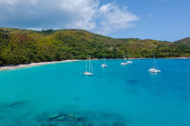 Turkuaz sular, Seyşeller 'deki Praslin Adası' nda nefes kesen bir sahil olan Anse Lazio 'da yavaşça kıyıya çarpıyor. Yeşillik cennet manzarasını güzelleştirirken yelkenliler huzur içinde süzülüyor..