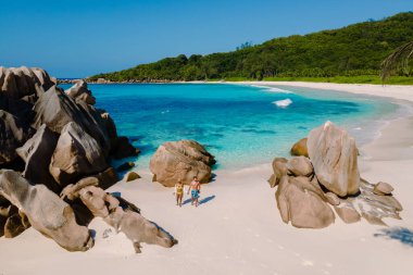 Immerse yourself in the tranquil beauty of Anse Cocos Beach on La Digue Island, Seychelles. A couple of man and woman on vacation at the beach