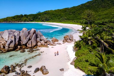 Stroll along the pristine white sands of Anse Cocos beach, surrounded by lush greenery and unique granite rocks. Experience the tranquility of this tropical paradise in Seychelles.