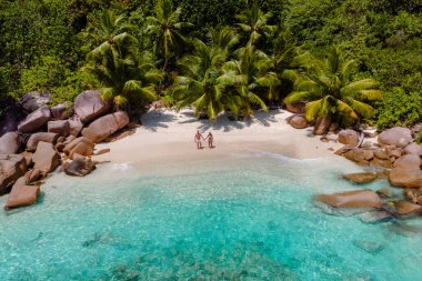 İki aşık, Anse Lazio 'nun yumuşak kumlu kıyılarında el ele yürür. Etrafı yemyeşil palmiyeler ve Seyşeller, Baie Sainte Anne' de kristal berraklığında turkuaz sularla çevrilidir..