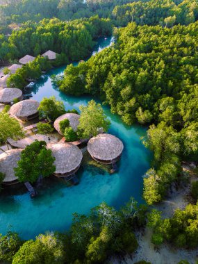 Nefes kesici bir hava manzarası, Koh Phayam Adası Tayland 'ın yemyeşil ve sakin mavi sularını yakalar ve mangrovlar arasında yuva yapmış bambu tatil beldelerini barındırır. Rahatlamak için mükemmel..