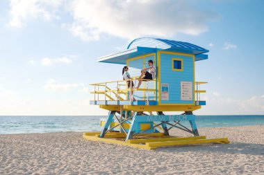 İki arkadaş Miami Sahili 'nde bir cankurtaran kulesinde güneşleniyorlar ve atmosferi canlı tutuyorlar. Sakin okyanus ve yumuşak kumlar mükemmel bir tatil zemini oluşturuyor..