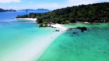 Trat, Tayland 'daki Koh Kham' ın dingin güzelliğini keşfedin. Bereketli yeşil manzaralar ve el değmemiş plajlar gezginleri dinlenmeye ve gevşemeye davet eder..