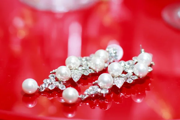 Earrings on a red background — Stock Photo, Image