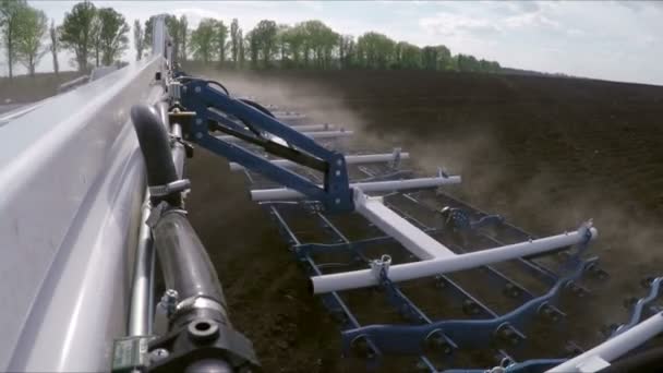 Harrow loosens the soil. Shooting with a camera mounted on the harrow — Stock Video