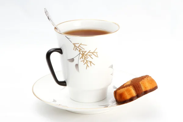 Cup of tea with a biscuit on the saucer — Stock Photo, Image