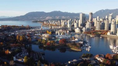 Vancouver şehir merkezinin hava manzarası ve etrafında renkli ağaçlar olan iki köprü.