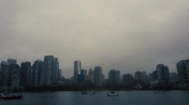 Vancouver şehir merkezinde bulutlu bir sabah ve önünde yatlar var.