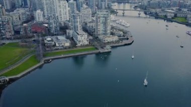 Su kenarındaki pist ve Vancouver şehir merkezindeki binalar.