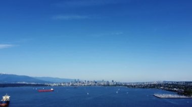 Aerial view of Vancouver downtown and English bay with cargo ships waiting