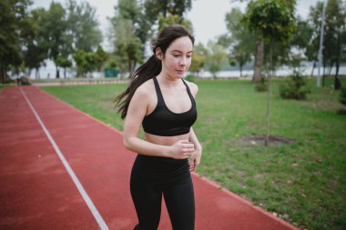 Genç kadın oyun alanında spor yapıyor.