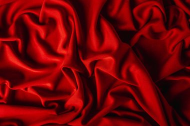 Güzel kıvrımlı kırmızı kumaş. Ürünün için arka plan. Lüks kumaşlar.