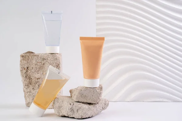 Krem, losyon ve temizlik jeli. Beyaz arka planda yüz bakımı kozmetikleri. Cilt sağlığı için kozmetik. C vitamini serumları, Unisex kozmetik ürünleri. Model. 