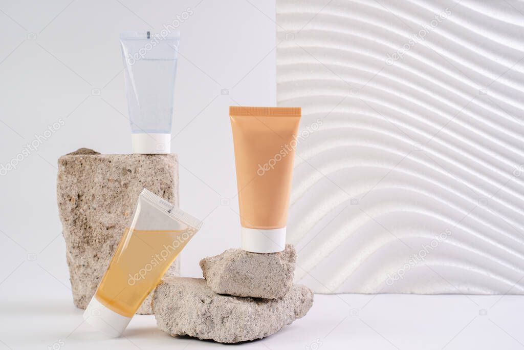 Cream, lotion and cleansing gel. Facial care cosmetics on a white background. Cosmetics for skin health. Serums with vitamin C. Unisex cosmetics. Mockup. 