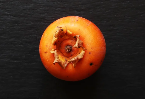 Bovenaanzicht Van Een Geïsoleerde Persimmon Leisteenachtergrond Voor Voedselillustraties — Stockfoto