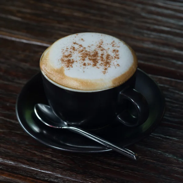 Café capuchino sobre tabla de madera como fondo — Foto de Stock