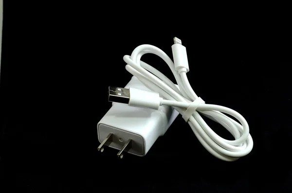 Cell phone charger isolate on black — Stock Photo, Image