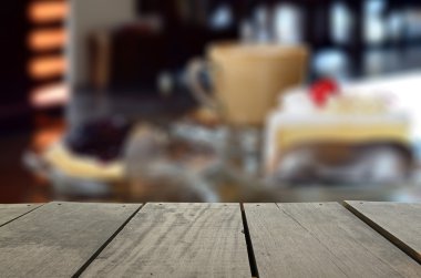 Defocused and blur image of cappuccino coffee and cake on desk for background usage clipart