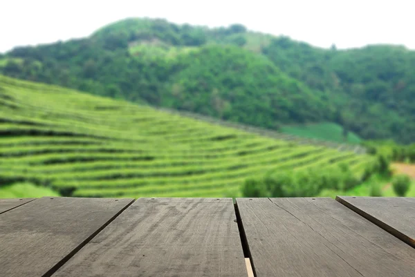 Perspective wood over blur beautiful tea faem and landscape mountain hill for background usage — Stock Photo, Image