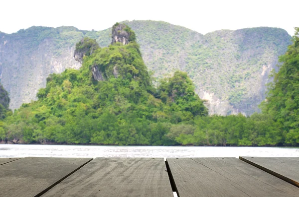 Defocus and blur image of terrace wood and Beautiful mountain midst of andaman sea for background usage — Stock Photo, Image