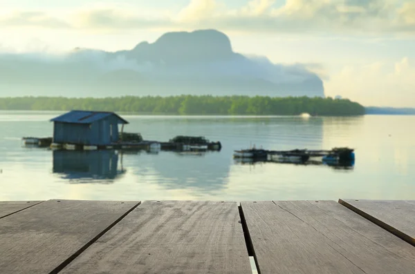 Defocus and blur image of terrace wood and Beautiful sunrise in beautiful seascape for background usage — Stock Photo, Image