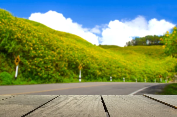 Defocus and blur image of terrace wood and sunflower field and r — Stock Photo, Image