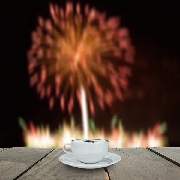 Fireworks blur background and coffee on terrace wood