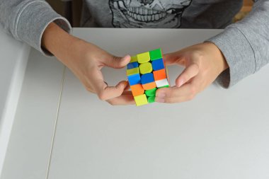 Perma, Rusya, Kasım 02 2020 Rubik küpü bir çocuğun elinde. Çocuk bir Rubik küpünü arka planda tutuyor, onunla oynuyor. Kapat..