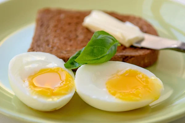 Two Soft Boiled Egg Halves Plate Basil Leaf Toast Butter — Stock Photo, Image