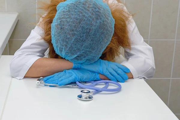 Doctor Está Durmiendo Con Cabeza Las Manos Mujer Adulta Cerca Imagen de archivo
