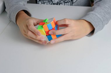 Hafif arka plandaki bir gencin elindeki mantıklı bir oyuncak. Çocuk onunla oynarken bulmacayı tutuyor. Kapat..