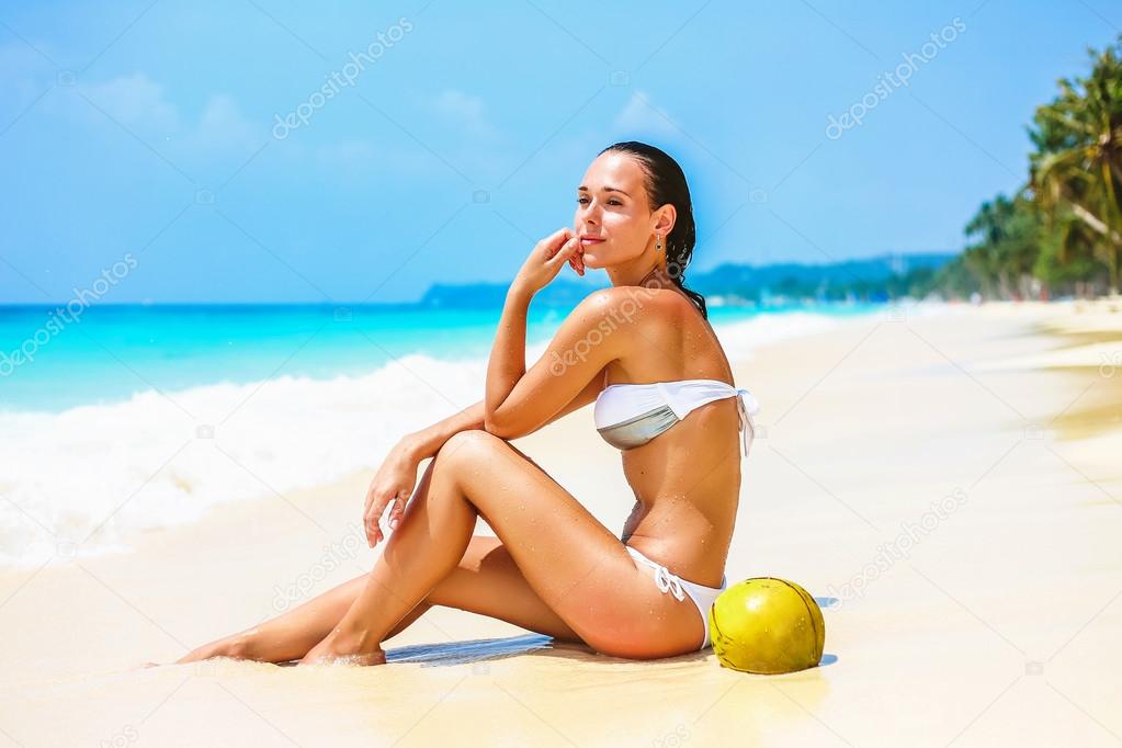 Young beautiful girl on tropical beach