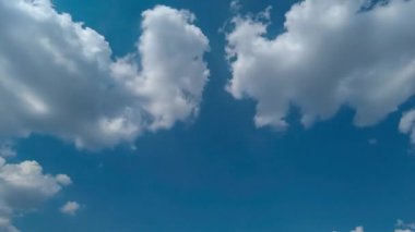 Güneşli bir yaz gününde gökyüzünde beyaz kümülüs bulutları belirir ve kaybolur. Zaman Uygulaması