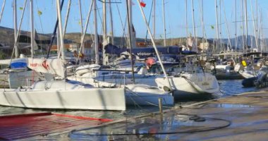Trogir, Hırvatistan - 6 Ağustos 2021: ACI marinası Hırvatistan 'ın Trogir kentinde. İnsanlar denize açılmadan önce son hazırlıklarını yaparlar. Güneşli bir yaz gününde rıhtımda demirli yatlar. Trogir 'deki ACI marinası yat kiralamak için popüler bir yerdir.. 