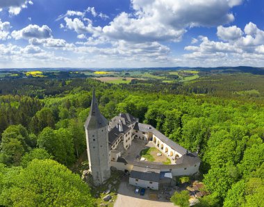 Gothic castle Rostejn near the village Doupe, stands on a rocky hill in the romantic landscape, Czech Republic clipart