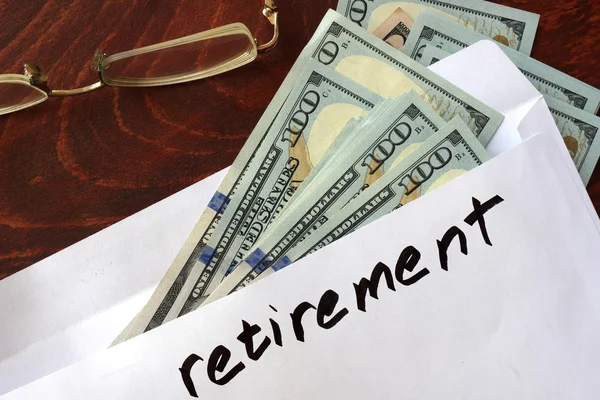 Retirement written on an envelope with dollars. — Stock Photo, Image