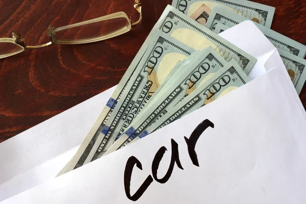 Car written on an envelope with dollars. — Stock Photo, Image