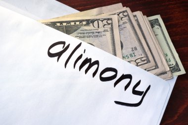 Alimony written on an envelope with dollars. clipart