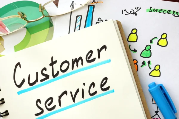 Customer service sign written in a notepad. — Stock Photo, Image