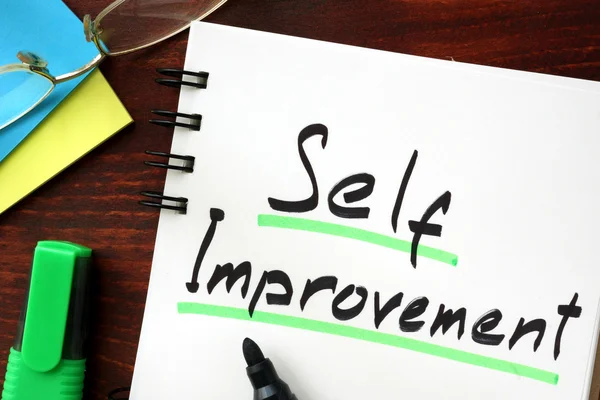 Self improvement sign written in a notepad. — Stock Photo, Image