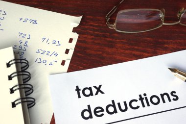 Tax deductions written on a paper. clipart