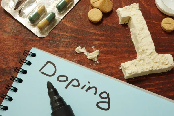 Caderno com Doping sinal, número um de pó, comprimidos e suplementos . — Fotografia de Stock