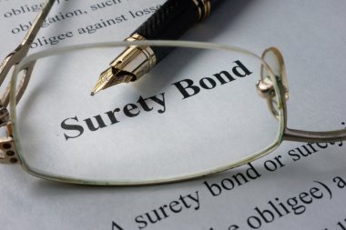Page of newspaper with words surety bond.   clipart